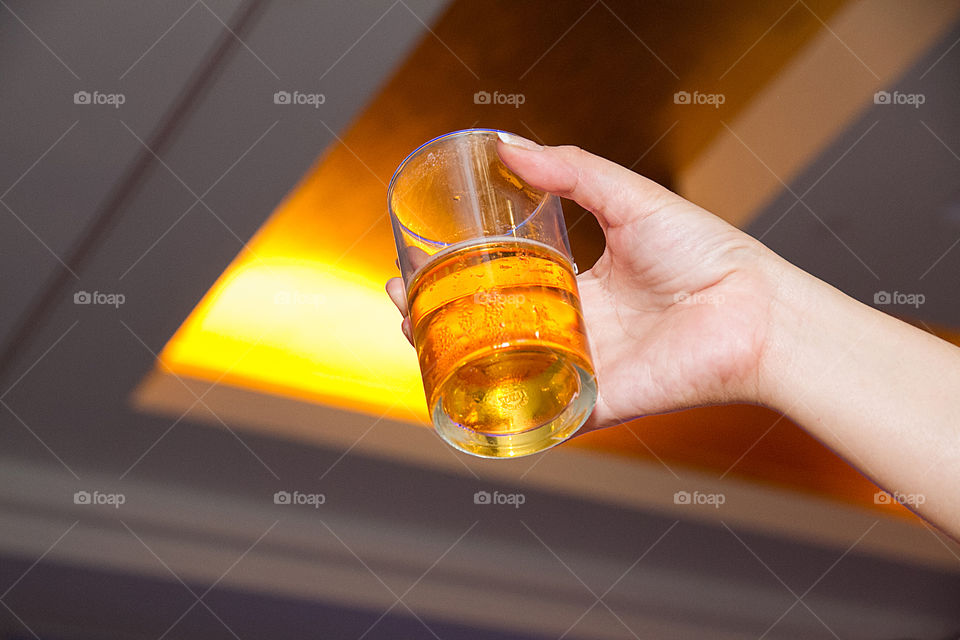 Person's hand holding drinking glass