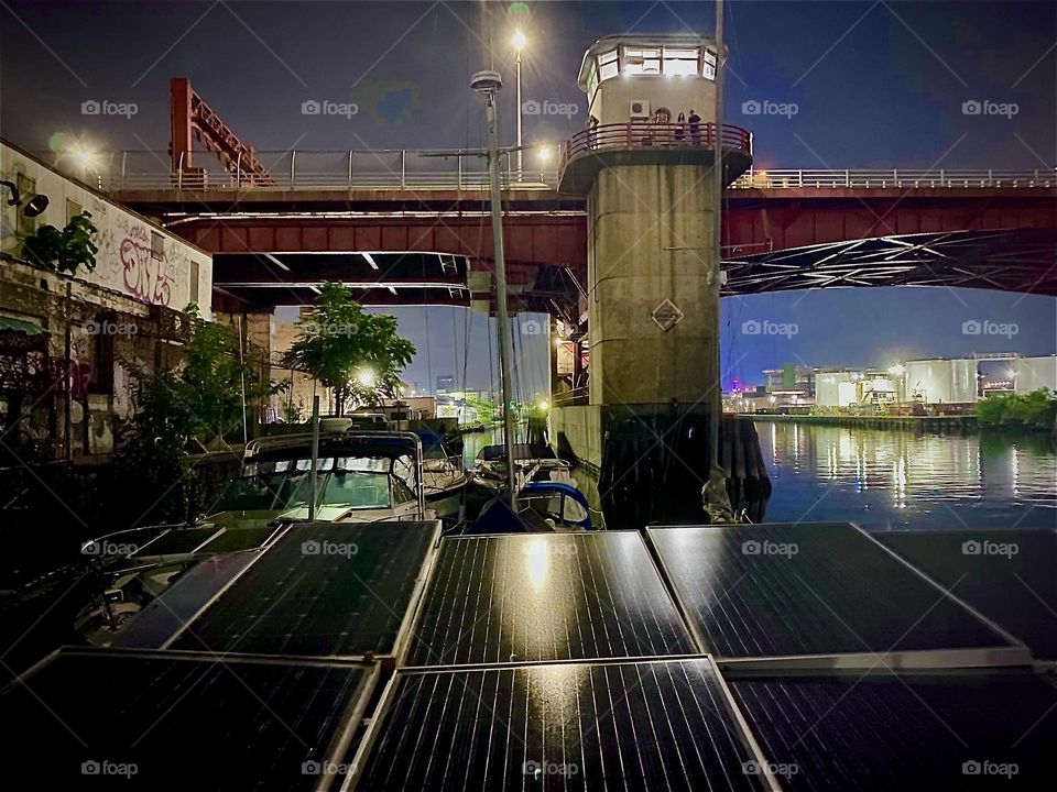 Another view of the „Pulaski Bridge“ at „Newtown Creek“ late at night on „July 4th, 2022“ or the Next day. The fireworks and various party events have come to an end and everybody is walking home. Hypnotic Productions