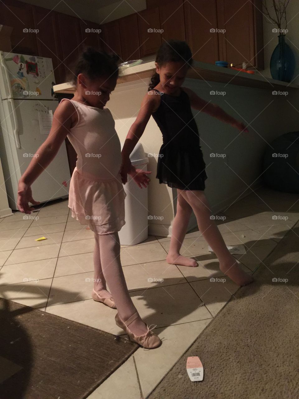 Ballet sisters. Big sister teaching her little sister what she learned in ballet.