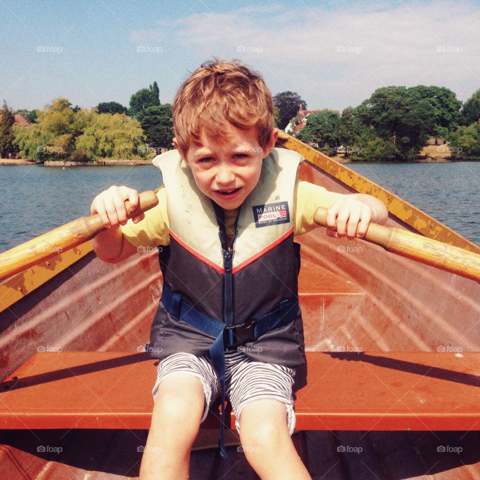 Seven year old boy rowing 

