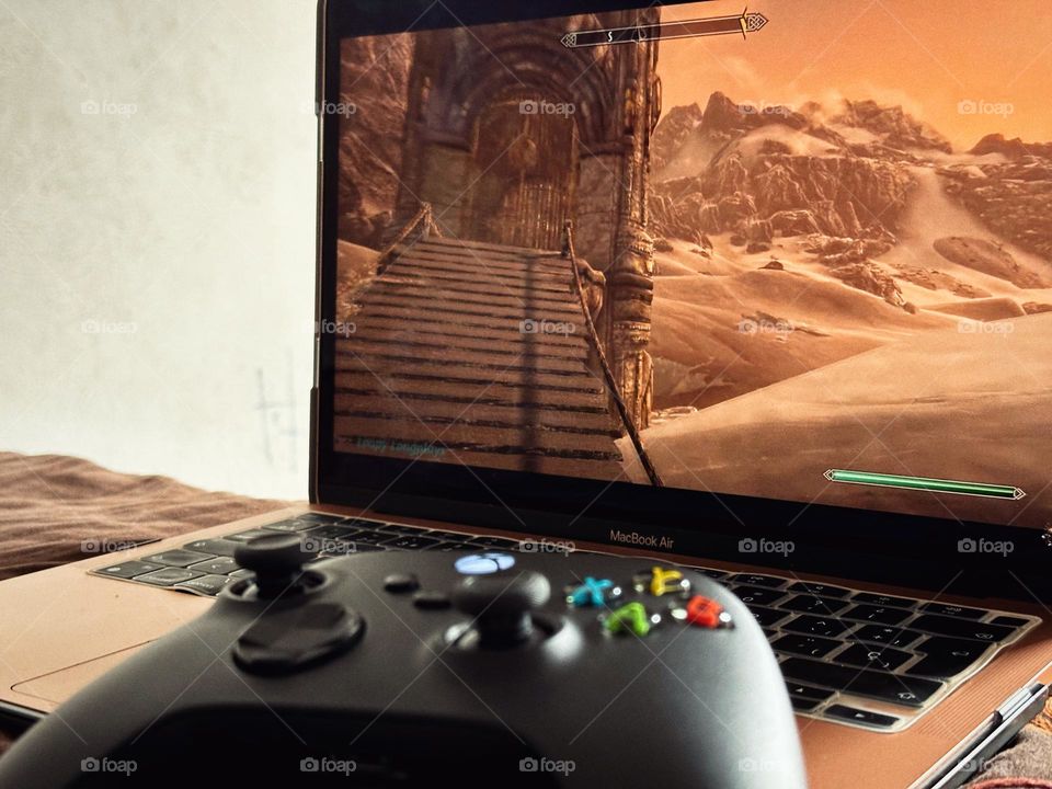 Xbox controller used to play Skyrim Videogame in a laptop.