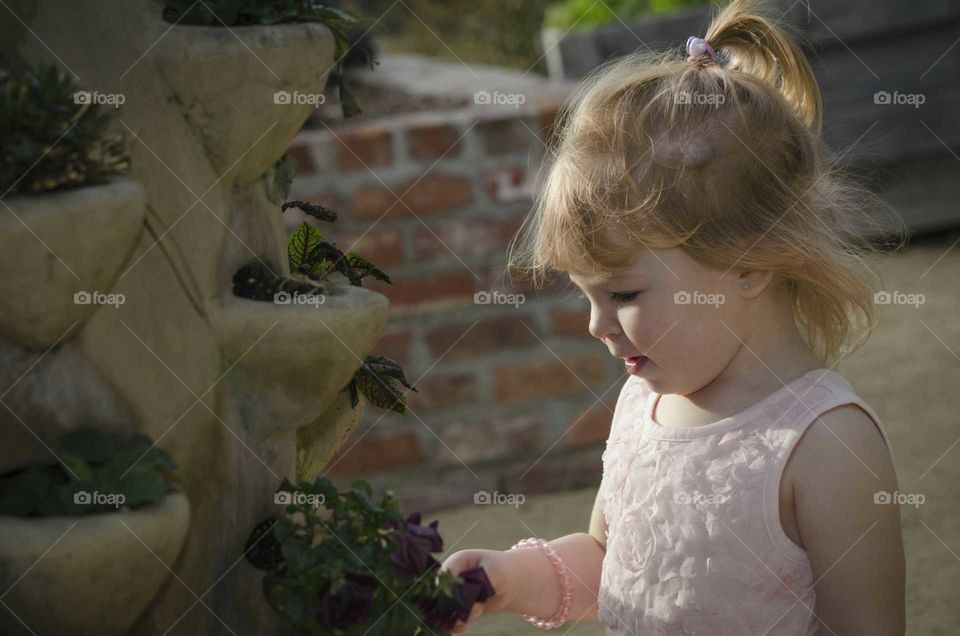 Little girl holding flower