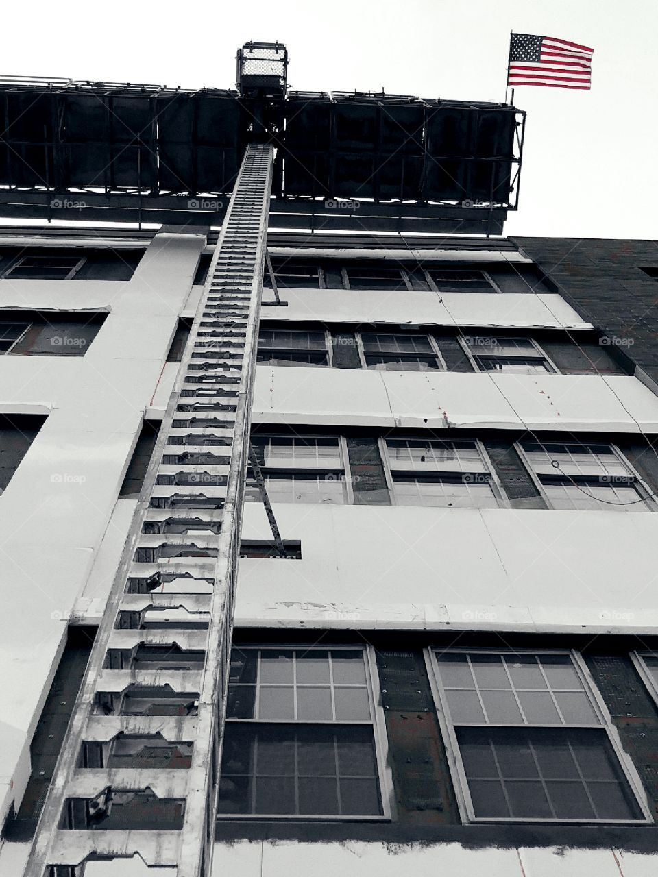 American flag hanging off a construction scaffold