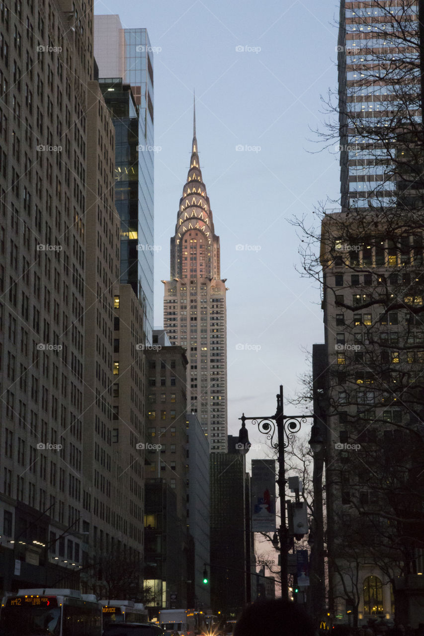 New York City - street at dusk - illuminated skyscraper 