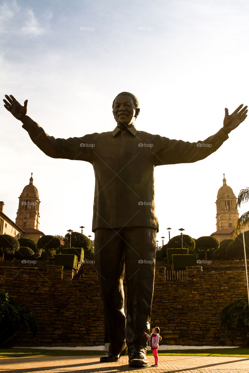 Little girl admiring the Nelson Mandela statue at the Union buildings in Pretoria South Africa. This is a historic site and frequently visited by tourists.