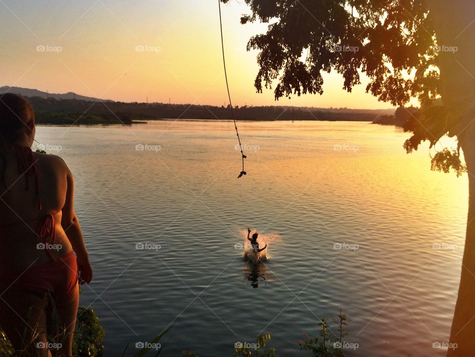 Rope jumping into the Nile River at sunset 