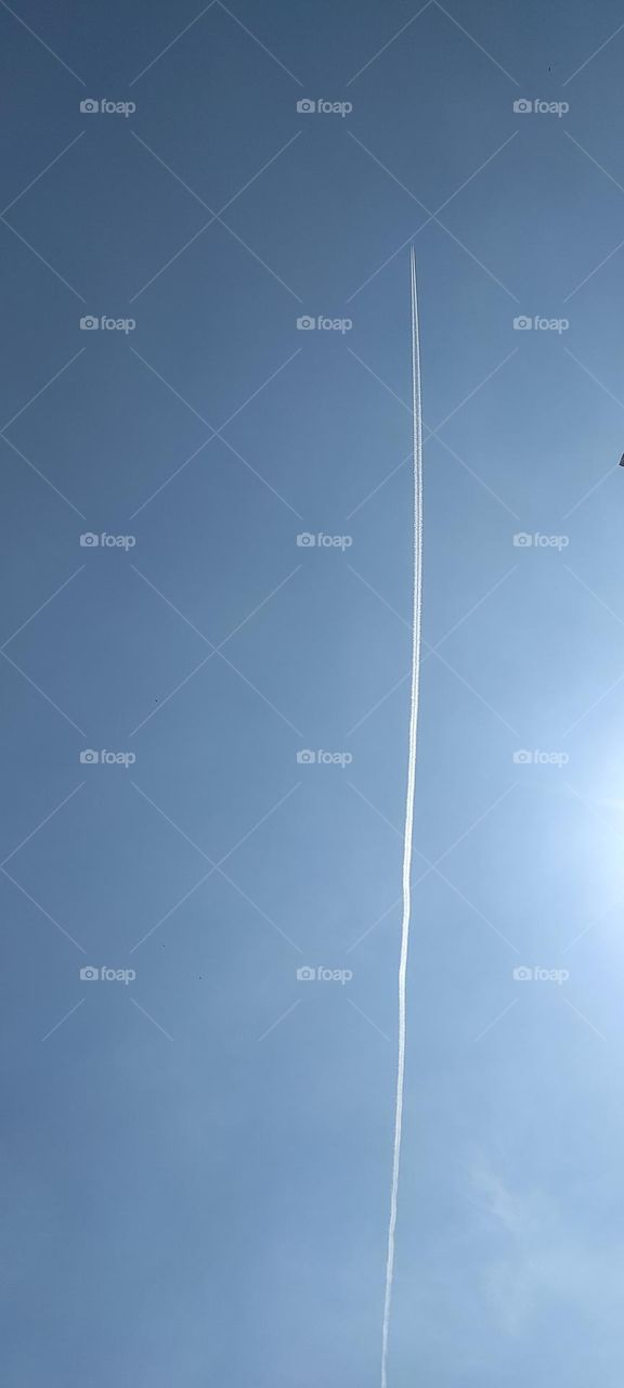 Contrails or vapor trails are line-shaped clouds produced by aircraft engine exhaust or changes in air pressure, typically at aircraft cruising altitudes several miles above the Earth's surface. Contrails are composed primarily of water.