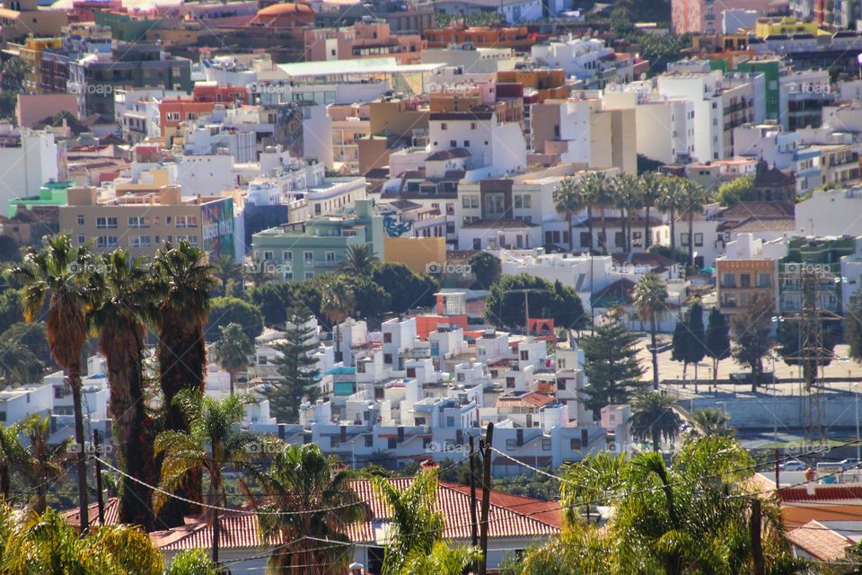 Aerial view over a city with colorful houses and palm trees on La Palma