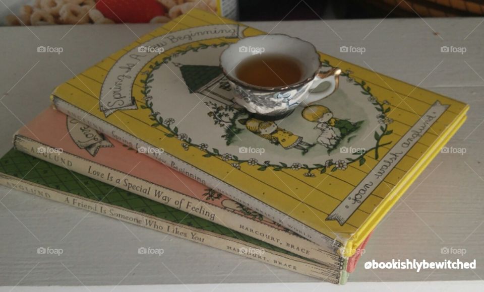 some old books from the 60s with a small cup of tea