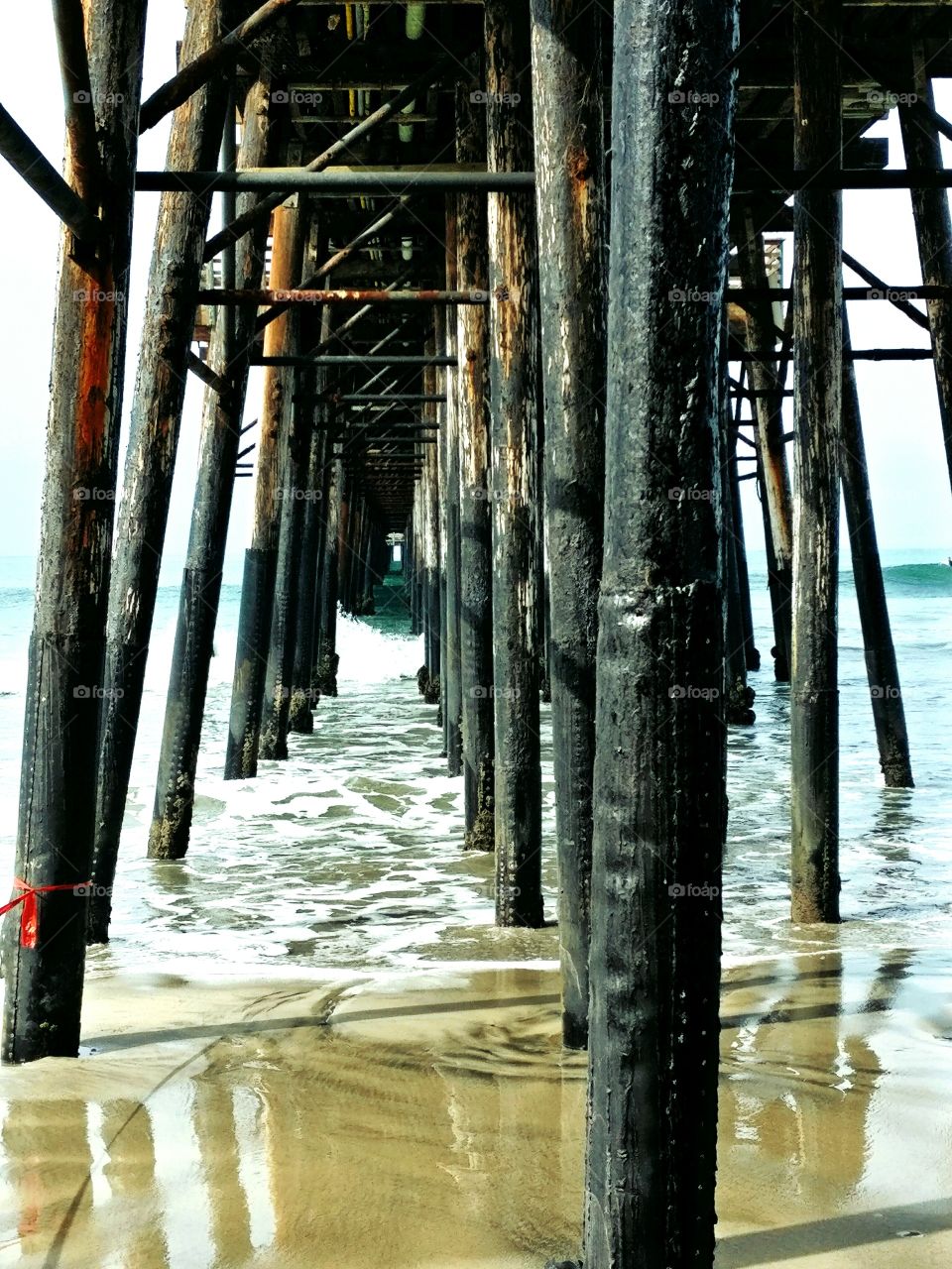 Close-up of old pier at beach