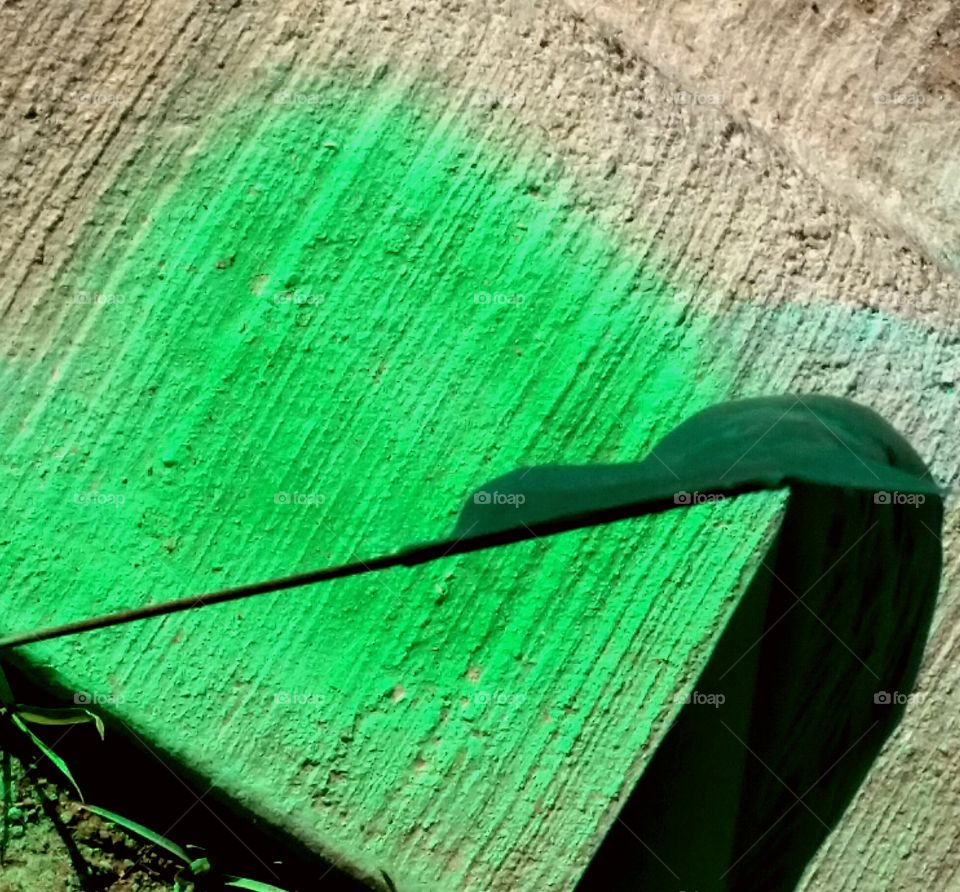 Green paint on concrete with green flag