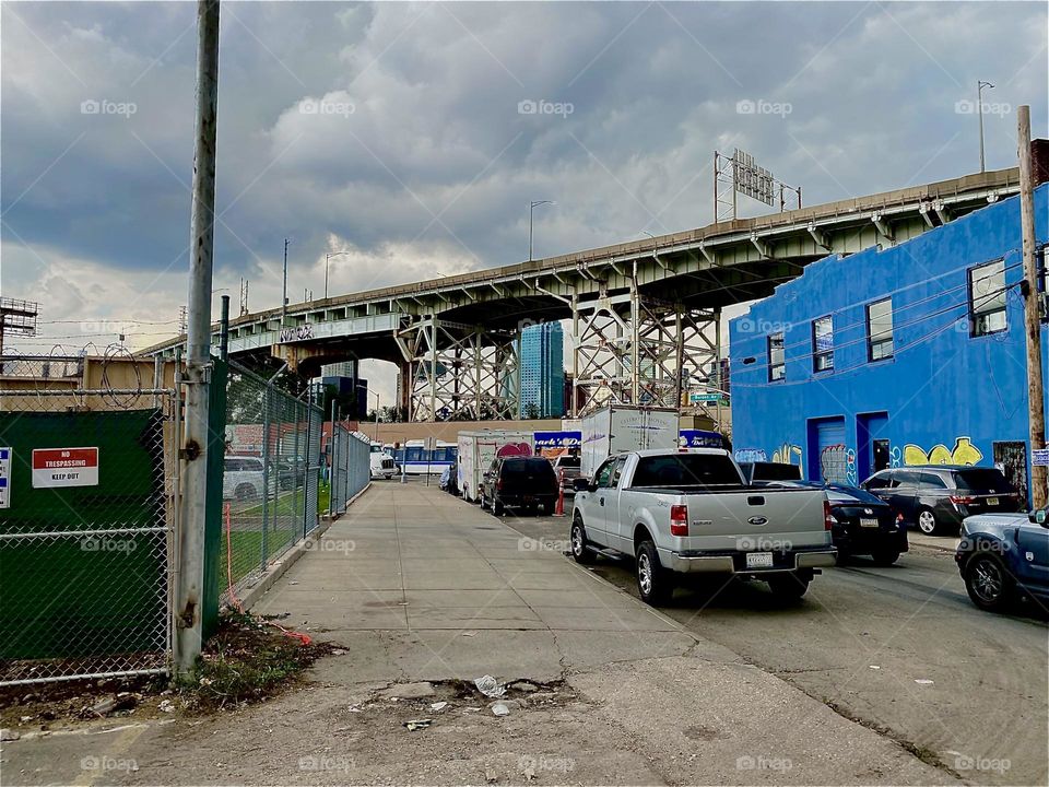 This is an above ground part of the “Brooklyn Queens Expressway” running parallel to “Borden Ave” and the “Borden Avenue Bridge” sloping slowly downward towards “Newtown Creek” and the “Pulaski Bridge” in LIC, Queens. 2023. Hypnotic Productions