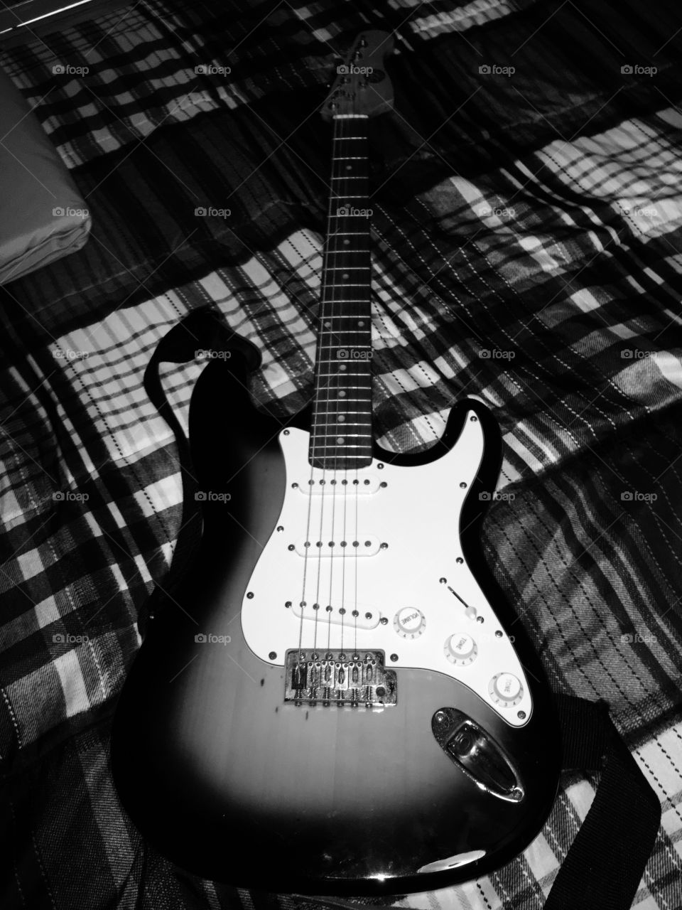 black and white minimalist electric guitar. Enjoy life by hearing music.