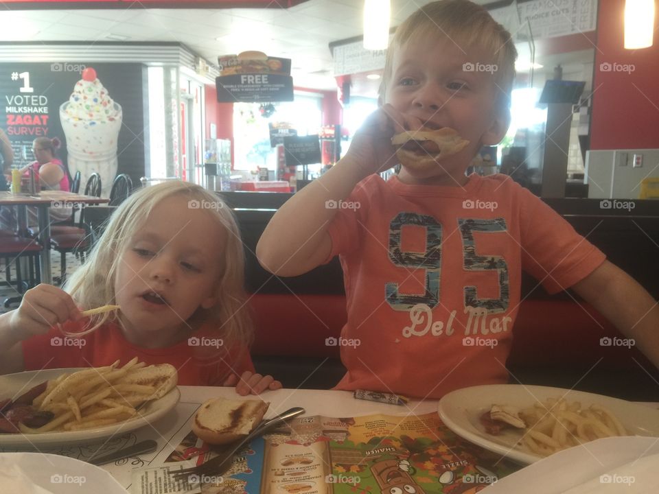 Lunch with twins. Siblings having lunch at a 50's diner