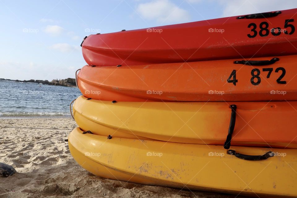 Colourful kayaks on the beach