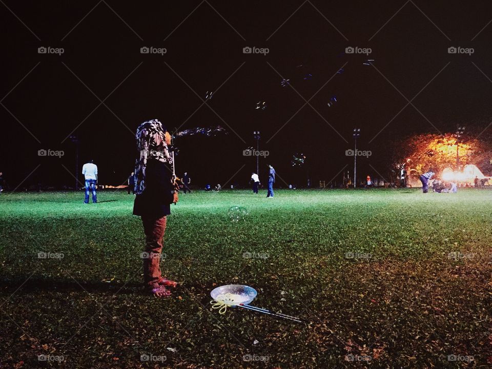 A little girl playing with bubbles