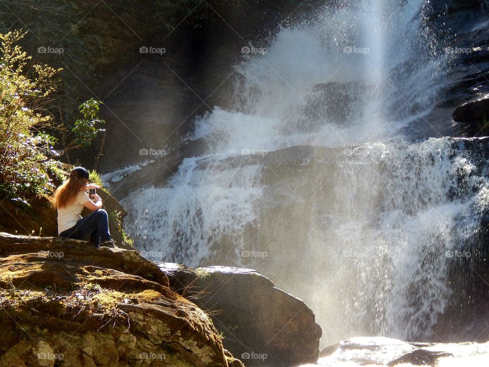 young lady photographing Mud creek falls in Sky Valley Georgia
