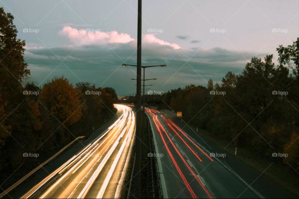 Long exposure of a highway from above with light trails from the front and rear lights