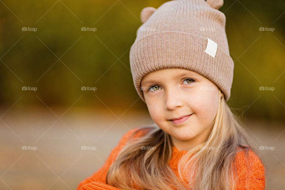 Portrait of cute little girl with blonde hair outdoor 