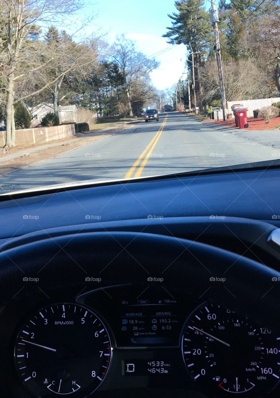 Driving in my car on residential, no passing street, through a town!