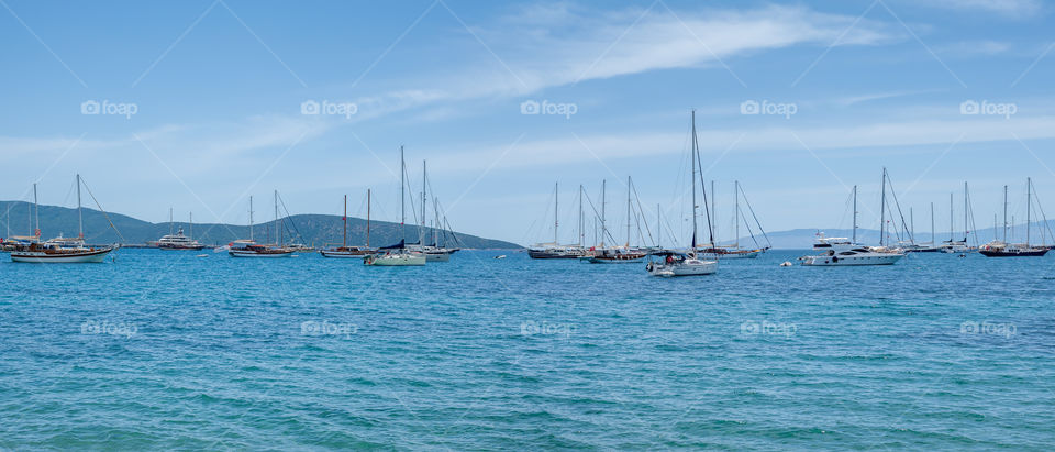 Yachts mooring in open sea.