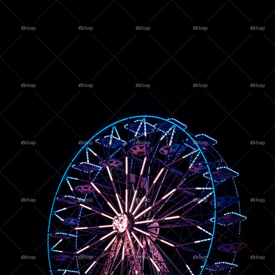 Low angle view of illuminated ferris wheel