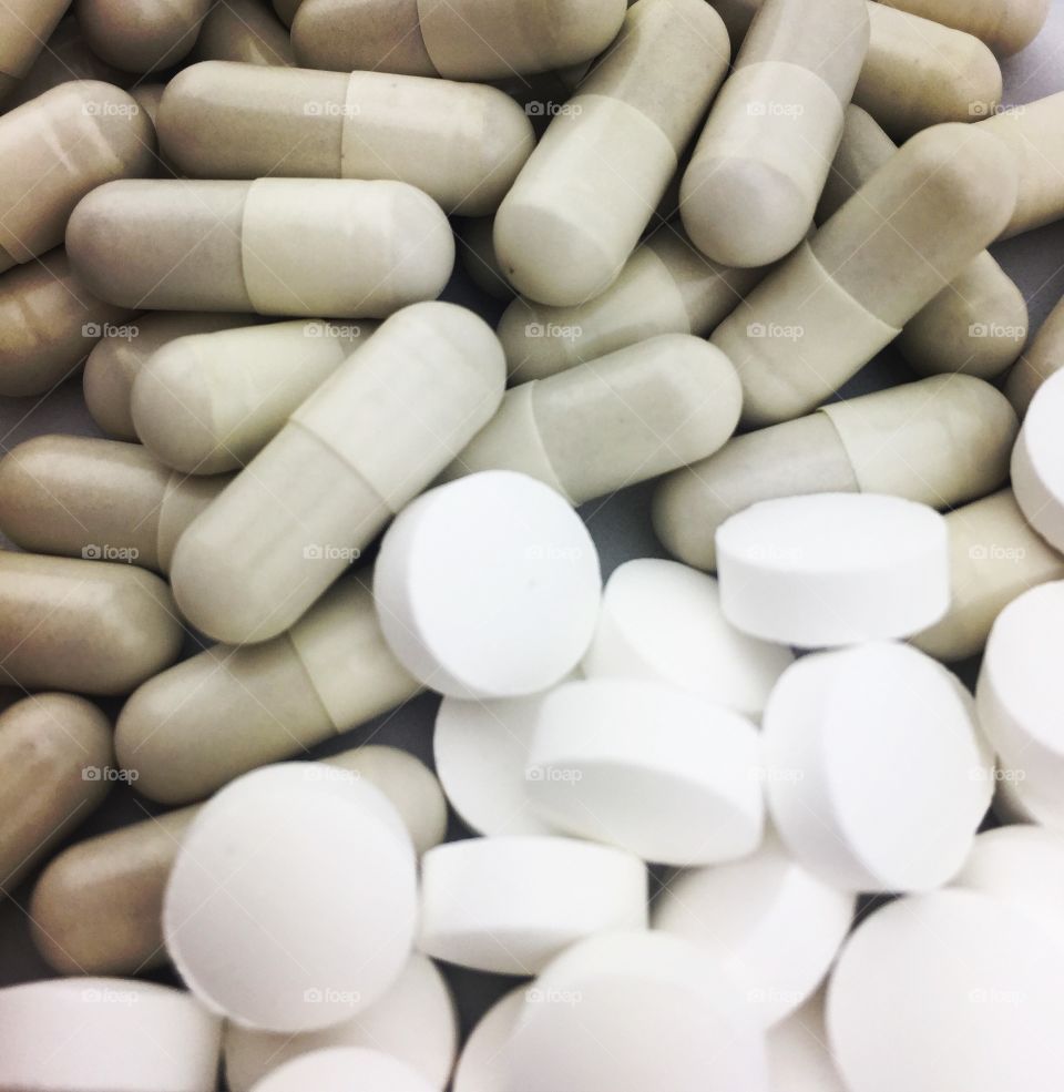 A pile of pharmaceutical, prescription or vitamin and mineral pills for illness 