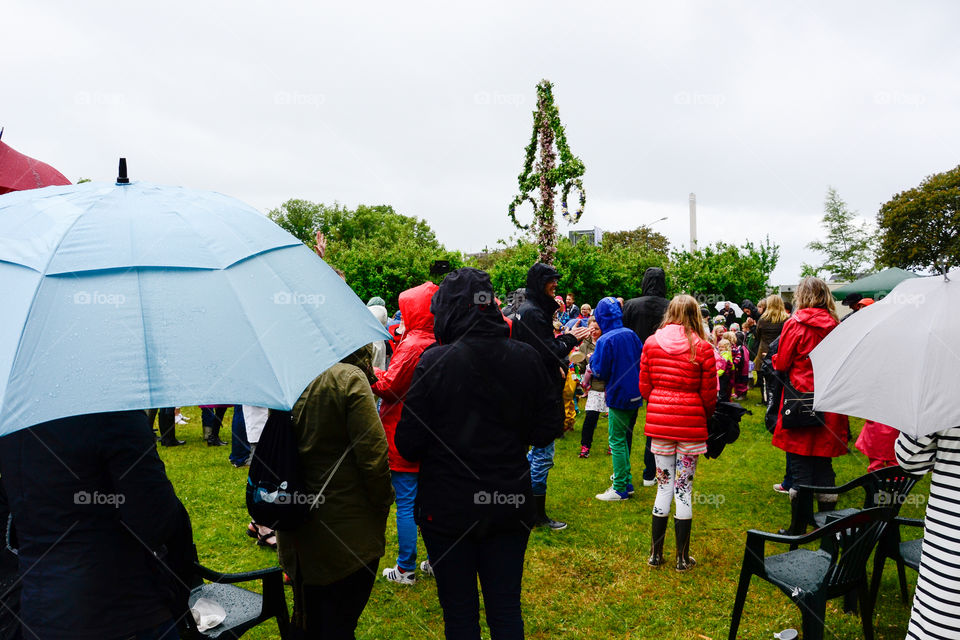 Swedish people is celebrating midsummer in the rain.