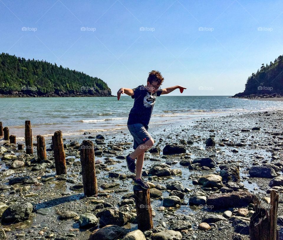 A boy does his best Karate Kid impression in Fundy National Park.
