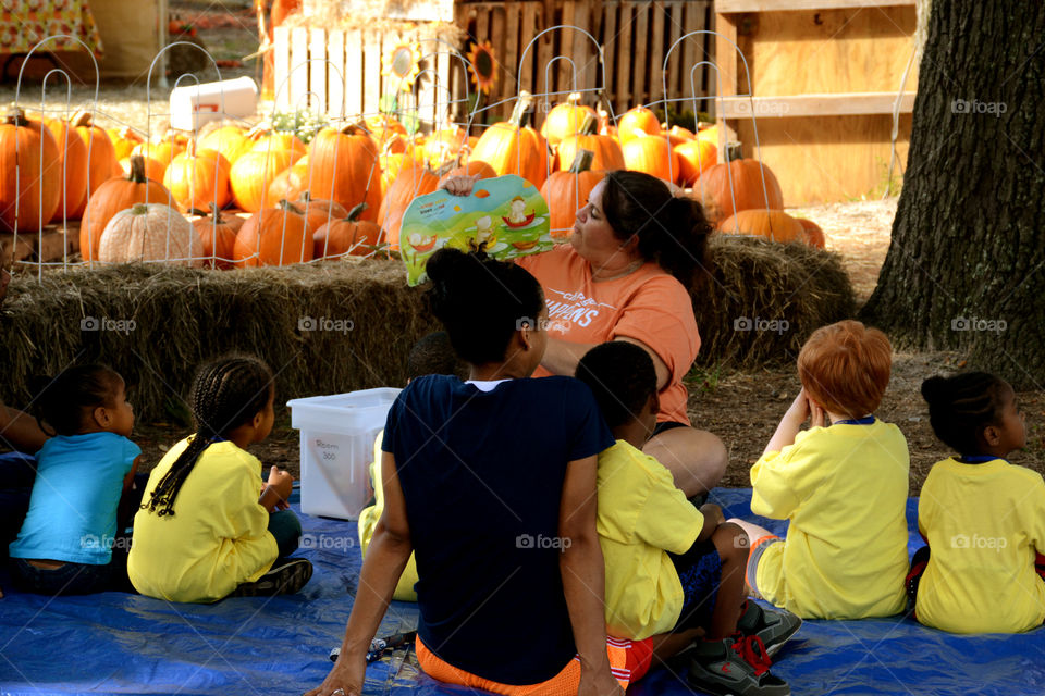 School is in. These students are getting a lesson on how pumpkins are grown from seed to full market growth!Students held pumpkin seed