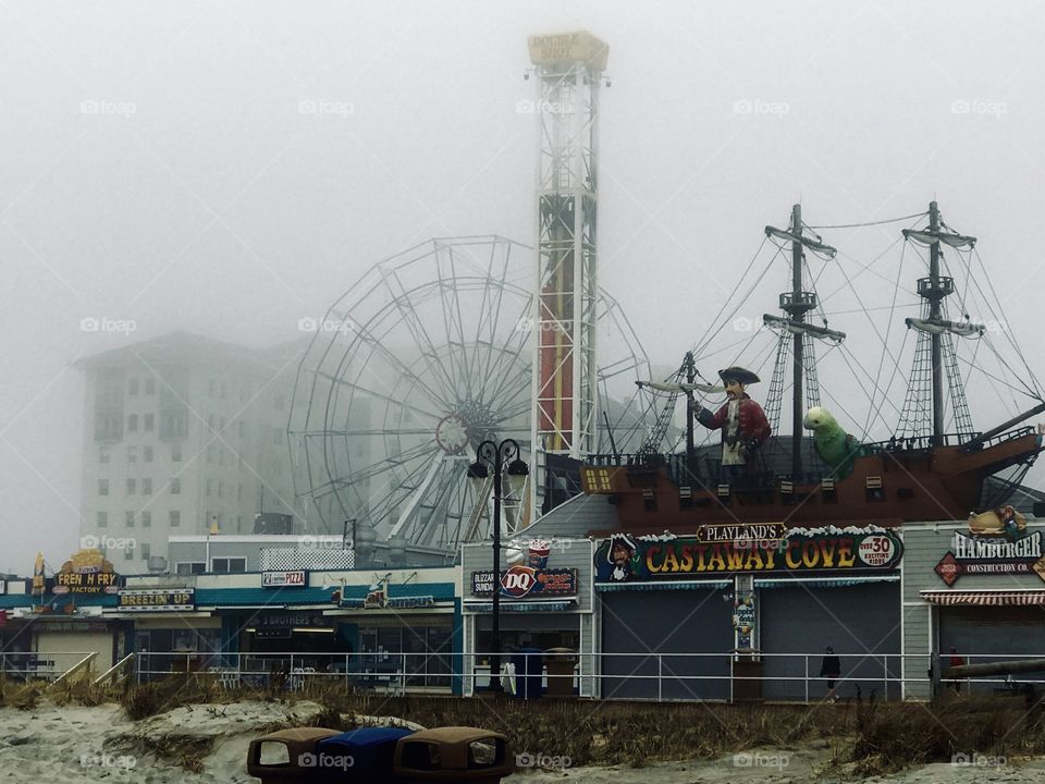 The ocean city boardwalk on a cloudy foggy afternoon before a storm. Shot on an early spring afternoon before the stores have opened for the season 