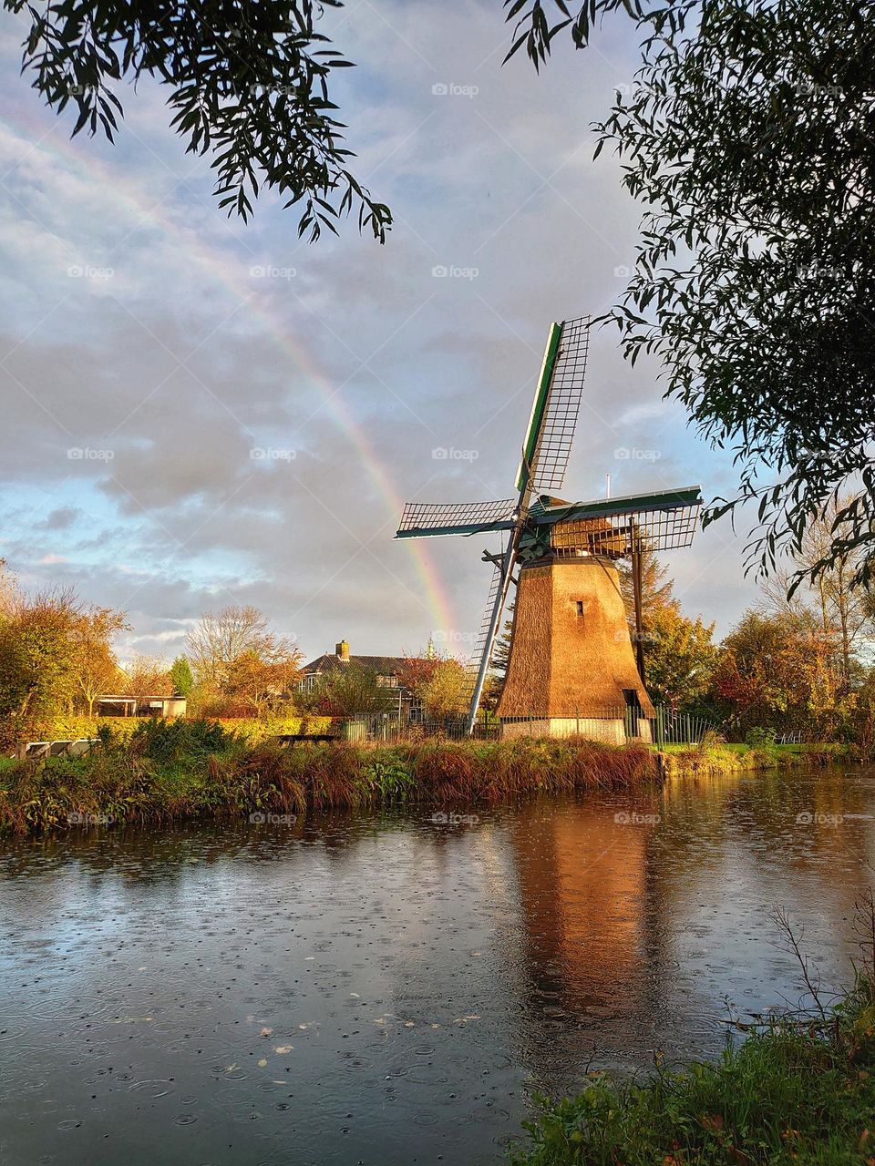 Rain, sun, rainbow and windmill