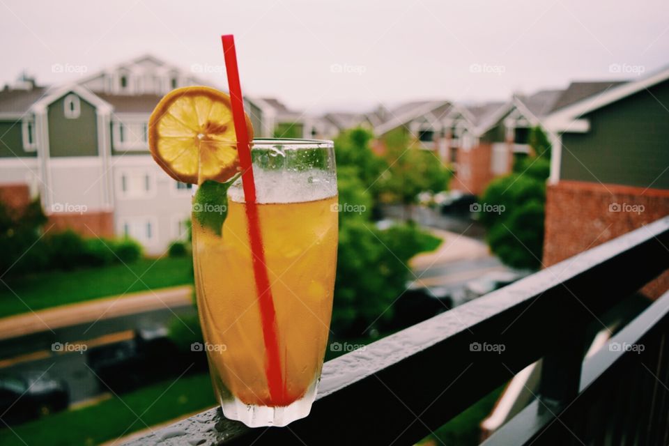 Drinking on the deck. Glass of iced tea