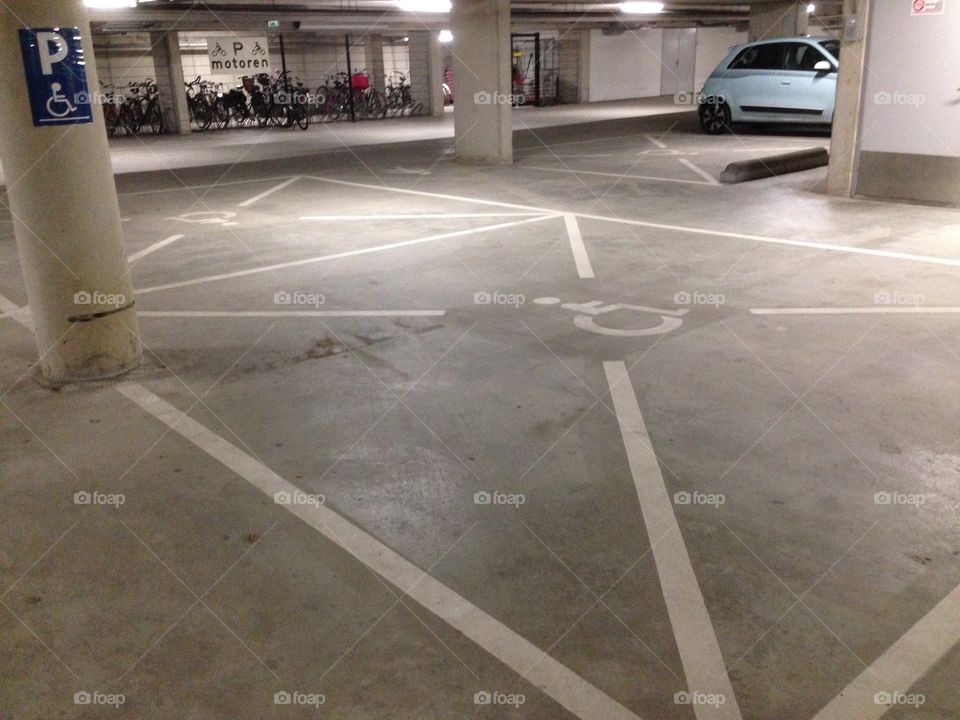 Handicap parking space in a underground parking garage. Reserved for disabled drivers.