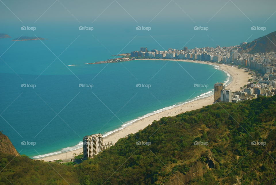 Top View of Copacabana Beach. shot from the top of the Sugarloaf Mountain, the postcard-worthy Copacabana Beach sizzles on a sunny afternoon