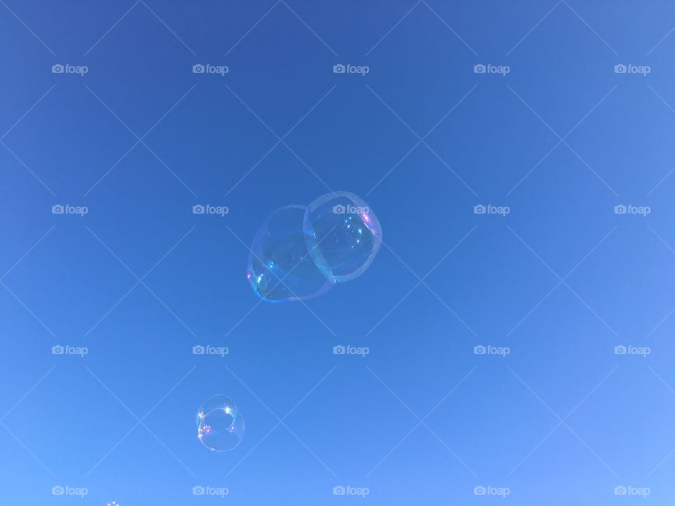 Soap bubbles flying in the sky