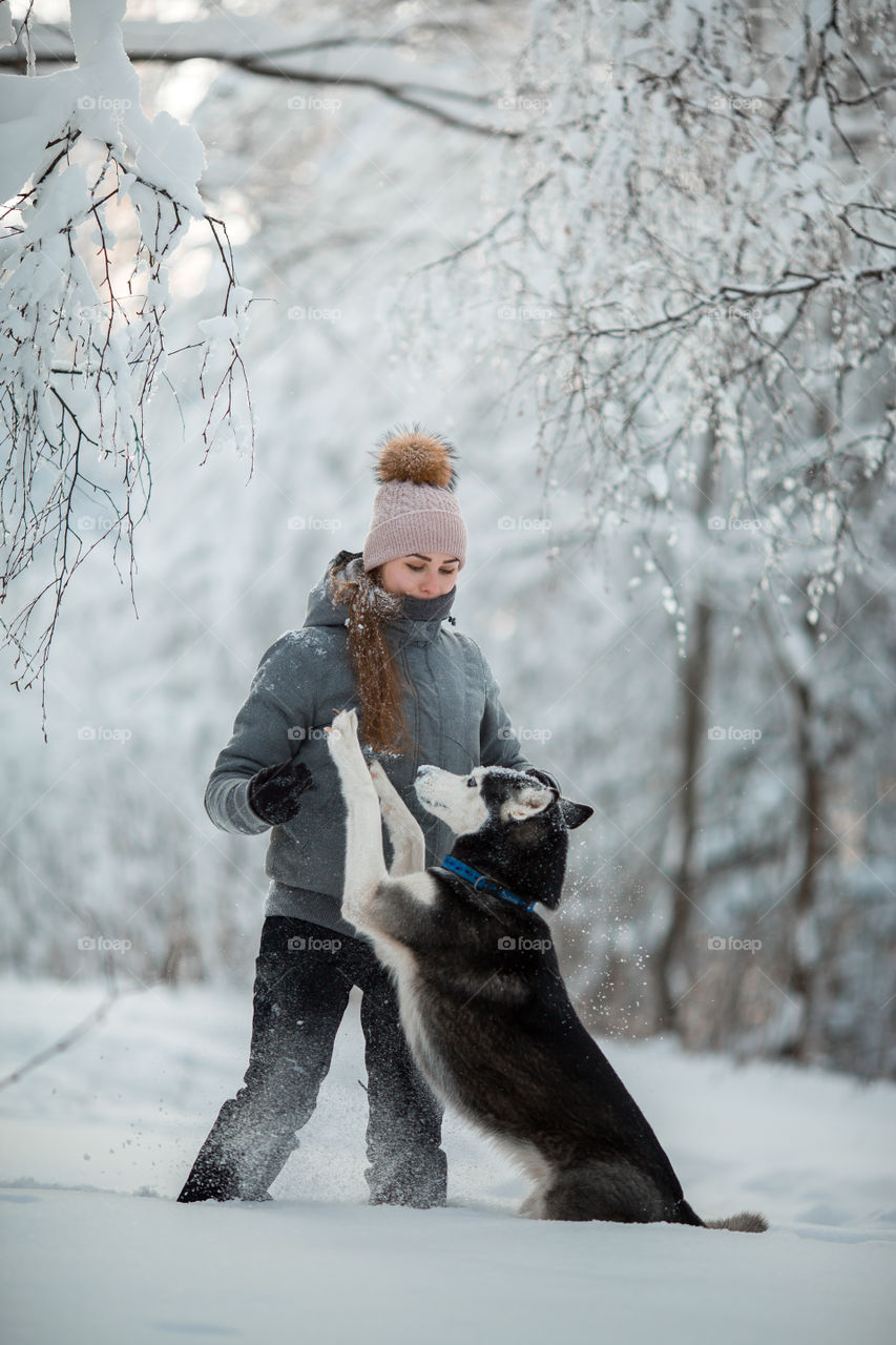 Walking with husky in winter park