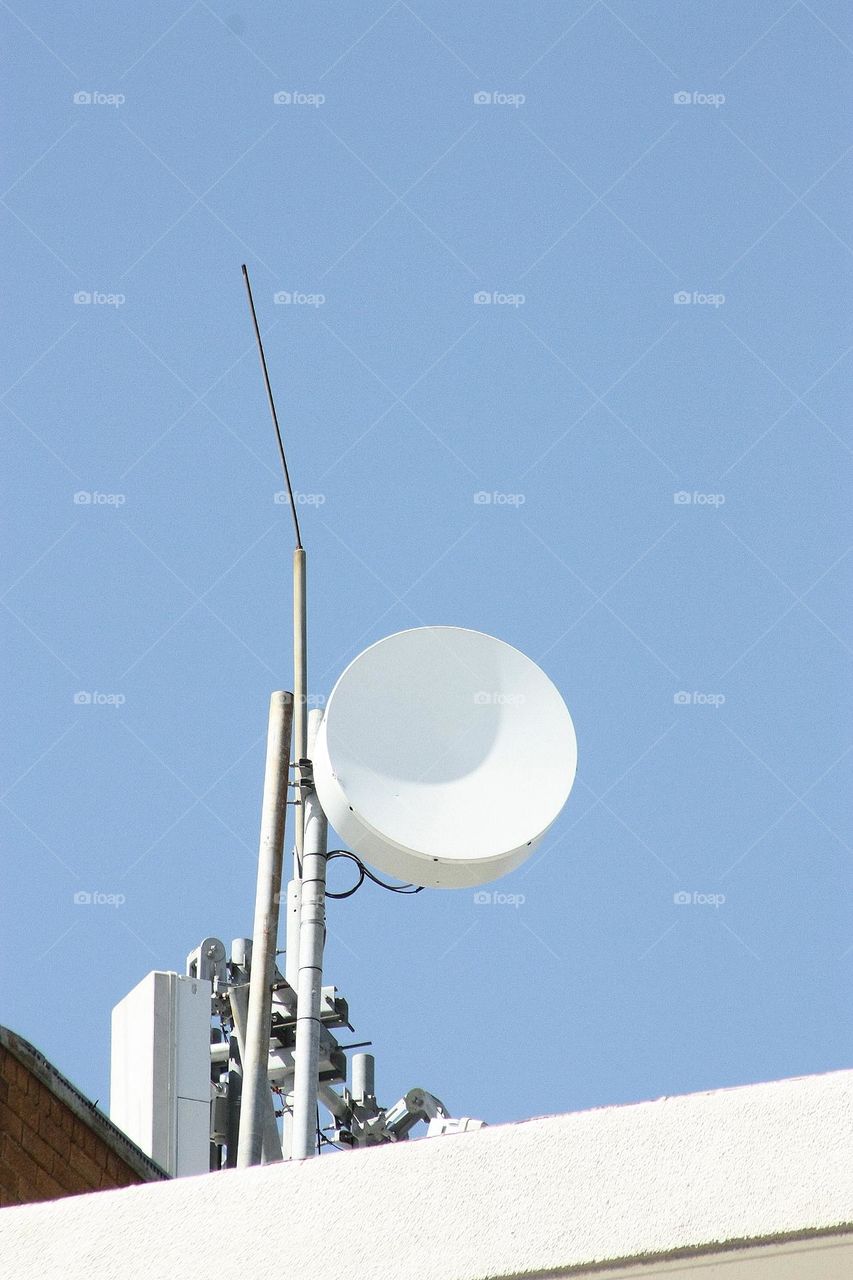 circular satellite dish on a roof