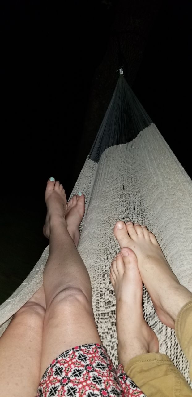 couple laying in hammock at night