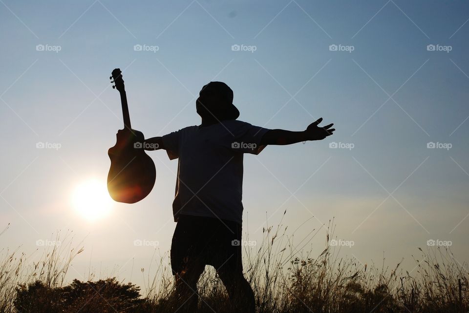 a man holding acoustic guitar.