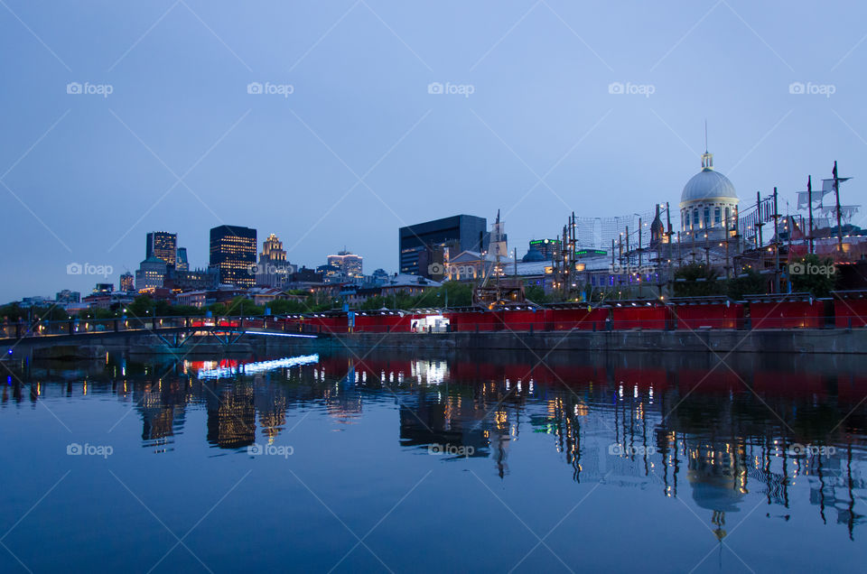 Old Port of Montreal, Quebec in the evening reflected in the water 