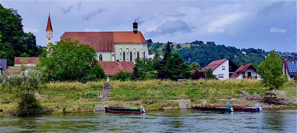This is a view of “Kelheim”, Bavaria from the “Danube” while passing by on a “Zille”, a historic large fishing row boat that nowadays offers tours between “Kelheim” and the “Weltenburg Abbey” at the “Danube Gorge”. 2024. Hypnotic Productions