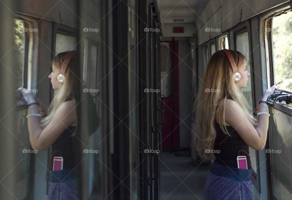 Girl listening to music in the train