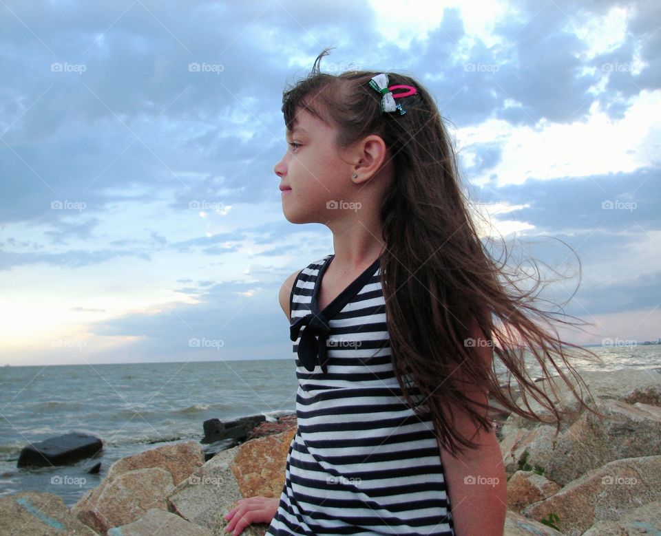 girl sitting and looking into a distance