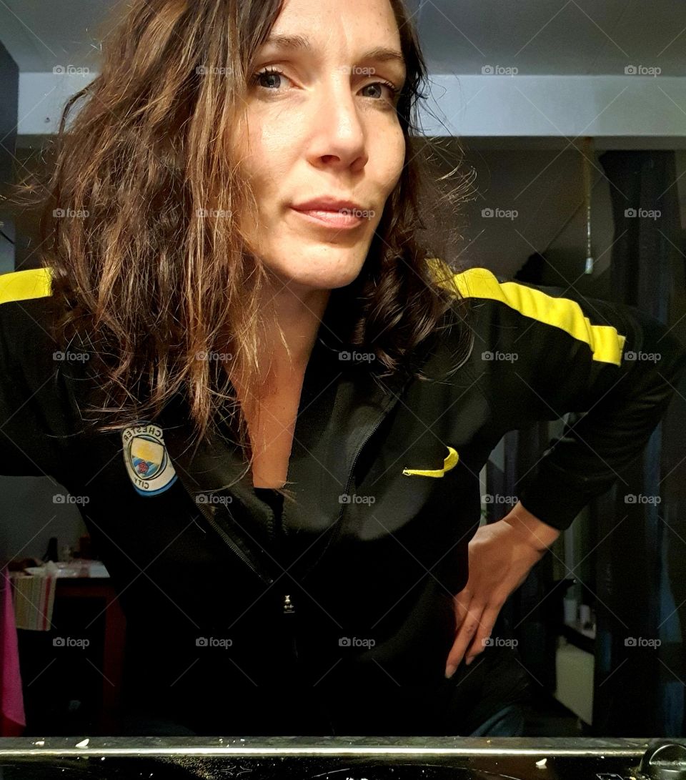 Looking into the camera with a small smile