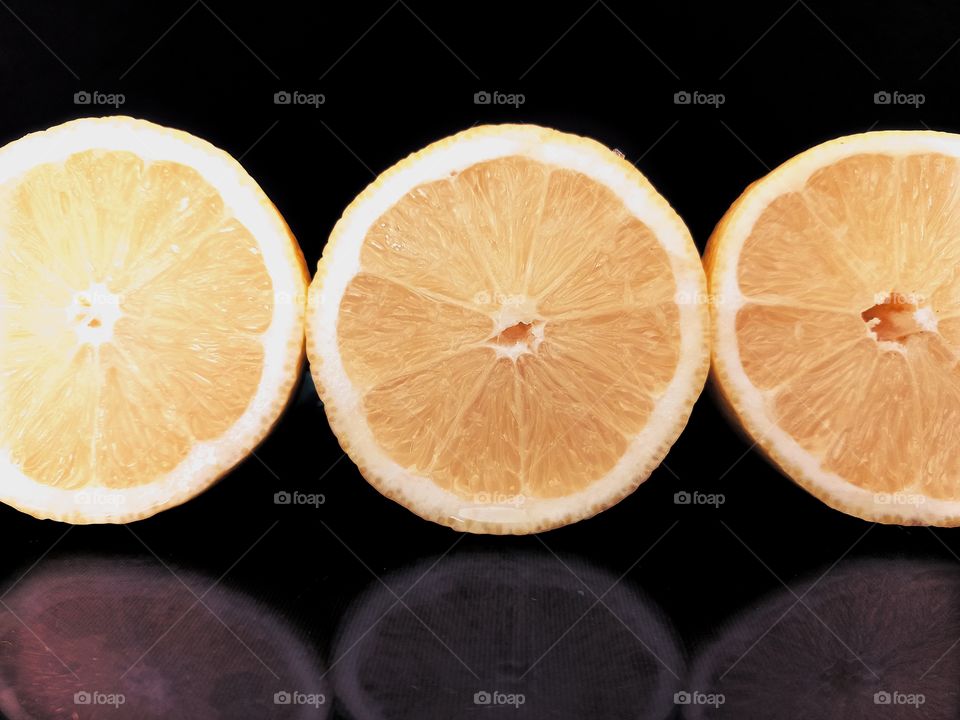 orange slices on black background