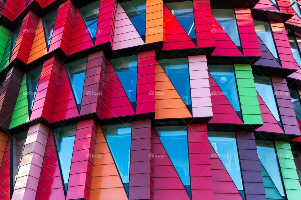 Colorful modern building in many bright colors with geometric windows and facade