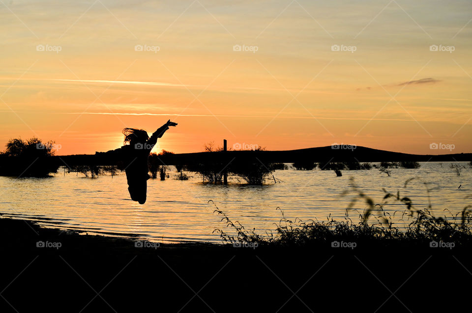 The sunset jump of joy, happiness, and pleasure for each of the accomplished day.