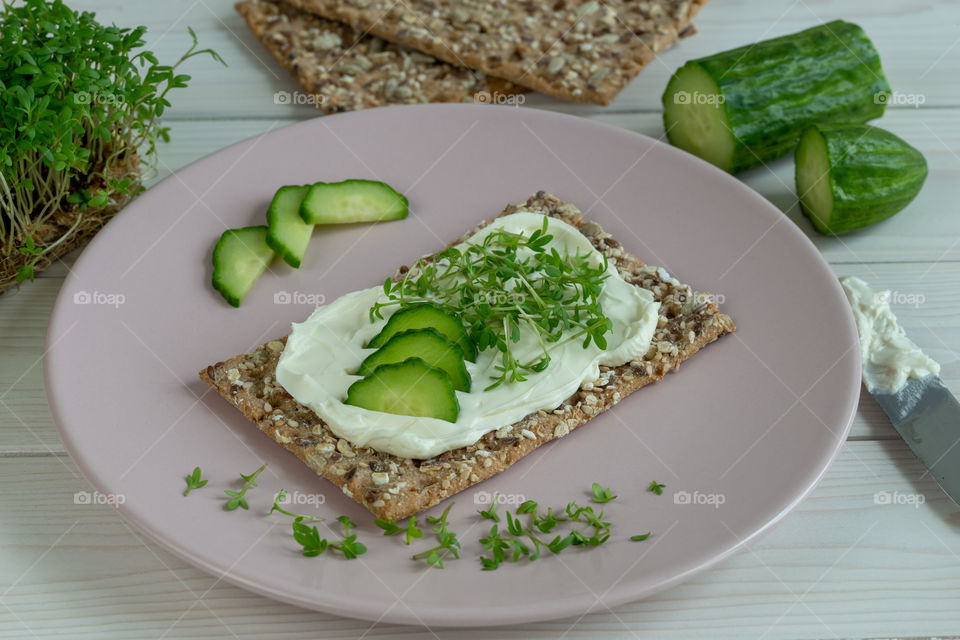 crisp bread with cream cheese and cress on a plate