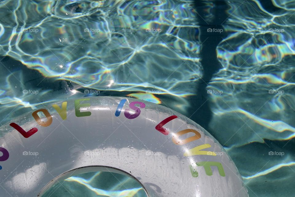 Love is love float in beautiful pool